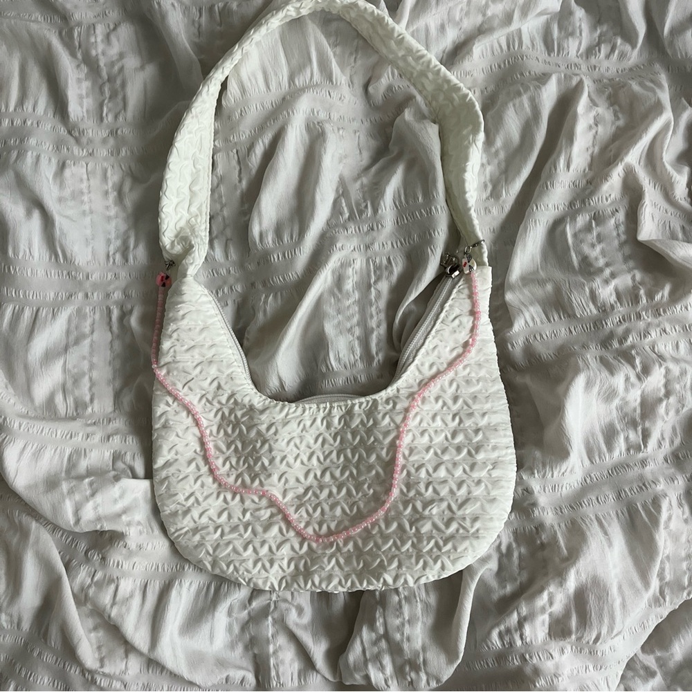 white casual bag with handmade charm